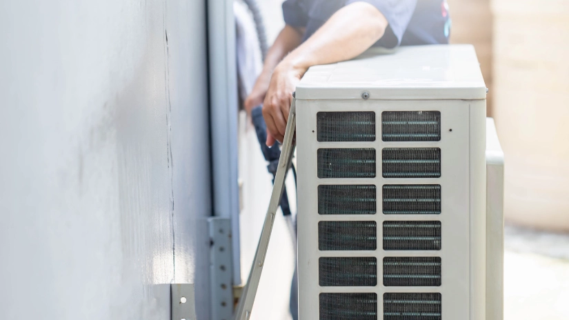 Electrician hands working behind air condition doing air conditioning maintenance