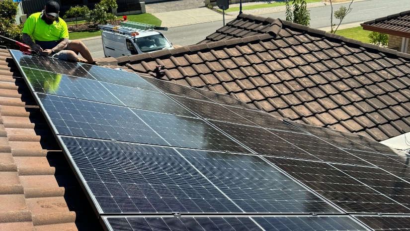 COYCO electrician on tiled roof installing solar panels. Choosing the right size solar system